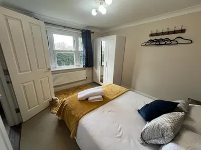 a bedroom with a large bed and a window at Riverview Colchester in Colchester