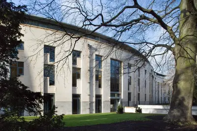 an exterior view of a white building with a tree at Stephen Hawking Building Gonville and Caius College in Cambridge