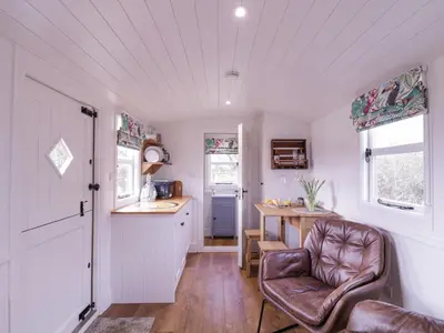 a kitchen with a chair and a table in a room at Bumble's Retreat in Whepstead