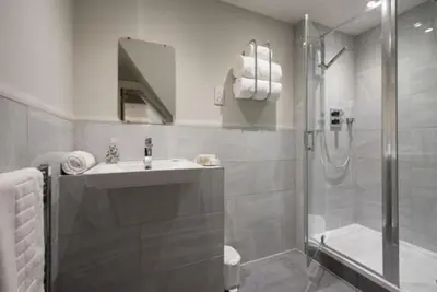 a white bathroom with a sink and a shower at Cosy, Bright, 1 Bed Flat in Brentwood