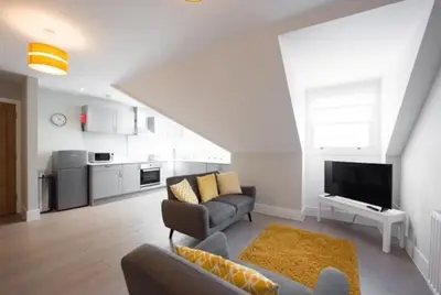 a living room with a couch and a tv at Cosy, Bright, 1 Bed Flat in Brentwood