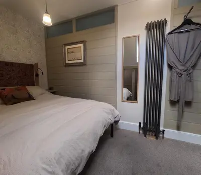 a bedroom with a white bed and a window at St Elmo Felixstowe in Felixstowe