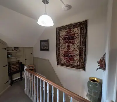 a rug hanging on a wall next to a staircase at St Elmo Felixstowe in Felixstowe