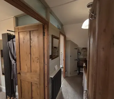 a hallway with a wooden door in a room at St Elmo Felixstowe in Felixstowe