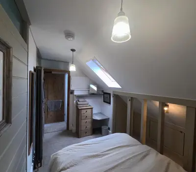 a bedroom with a bed and a skylight at St Elmo Felixstowe in Felixstowe