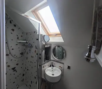 a bathroom with a sink and a skylight at St Elmo Felixstowe in Felixstowe