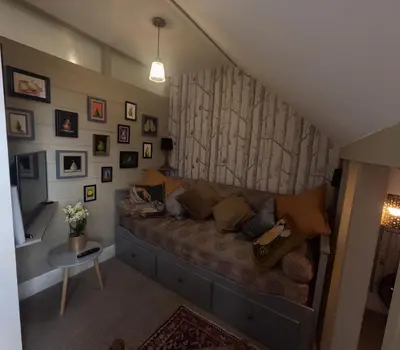 a living room with a couch in the corner at St Elmo Felixstowe in Felixstowe