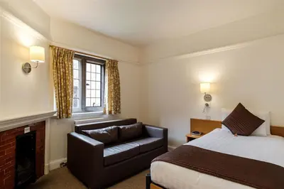 a hotel room with a bed and a couch at Westminster College in Cambridge