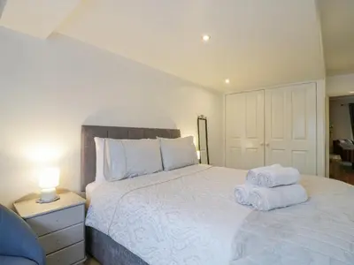 a bedroom with a bed with towels on it at Hide and Sleep in Walton-on-the-Naze