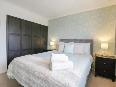 a bedroom with a bed with two towels on it at Hide and Sleep in Walton-on-the-Naze