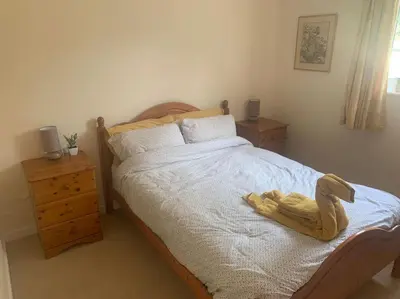 a bedroom with a bed with a towel on it at Relaxing country cottage bungalow in Yaxley