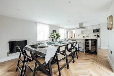 a dining room with a table and chairs in a kitchen at Fun house in the heart of Colchester in Colchester