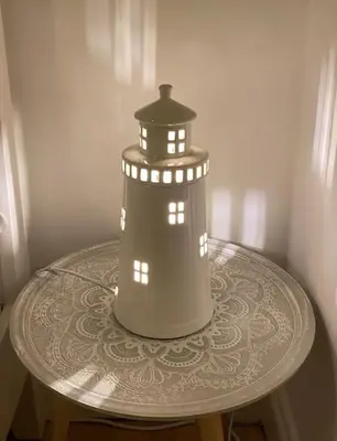 a model of a lighthouse sitting on a table at Shoreline hideaway - next to the beach in Holland-on-Sea