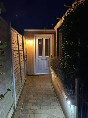 a front door of a house at night at Shoreline hideaway - next to the beach in Holland-on-Sea