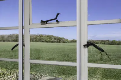 an open window with a view of a field at Crows Hall in Colchester