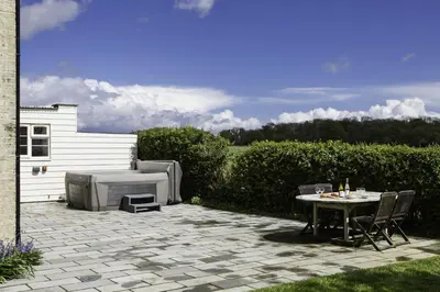 a patio with a table and a grill at Crows Hall in Colchester
