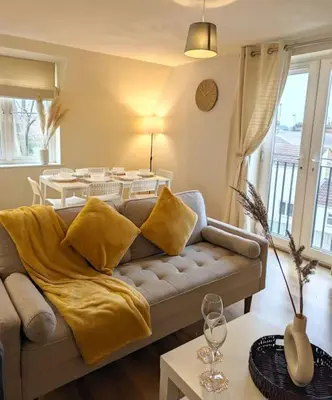 a living room with a couch and a table at 3-Bed, Sleeps 6, 1 Bath, Parking, WiFi in Bramford