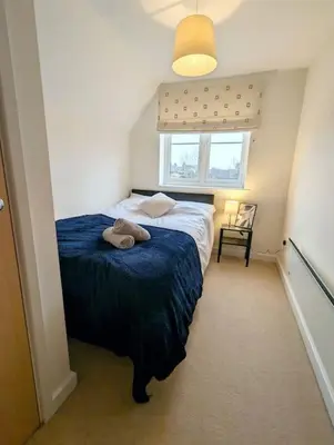 a bedroom with a bed with two towels on it at 3-Bed, Sleeps 6, 1 Bath, Parking, WiFi in Bramford