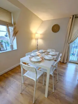 a white dining room table with white chairs and a white tableearcher at 3-Bed, Sleeps 6, 1 Bath, Parking, WiFi in Bramford