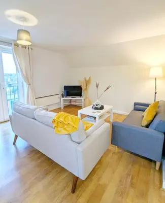 a living room with a couch and a table at 3-Bed, Sleeps 6, 1 Bath, Parking, WiFi in Bramford