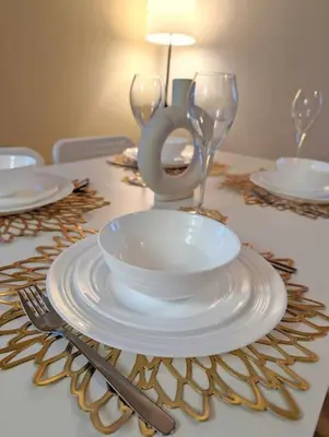 a table with plates and glasses on a table at 3-Bed, Sleeps 6, 1 Bath, Parking, WiFi in Bramford