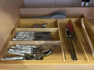 a wooden drawer with some utensils in it at BelLa VistA - Holiday Home On The Beach in Clacton-on-Sea