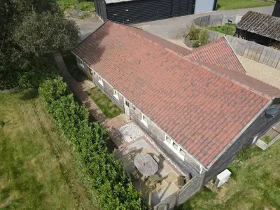 an overhead view of a building with red roofs at A family and dog friendly haven, The Hayloft. in Saxmundham