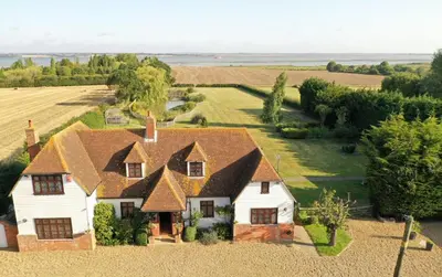 an aerial view of a house in a field at Bellropes Countryside Retreat in Bradwell on Sea