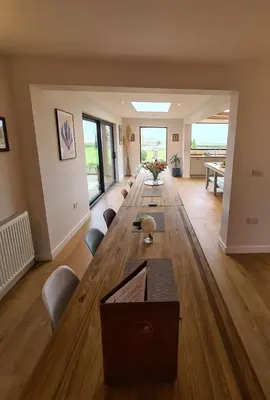 a large living room with a long table and chairs at Bellropes Countryside Retreat in Bradwell on Sea