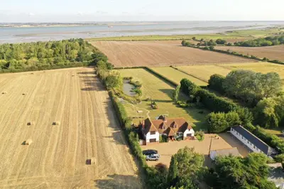 an aerial view of a house and a field at Bellropes Countryside Retreat in Bradwell on Sea