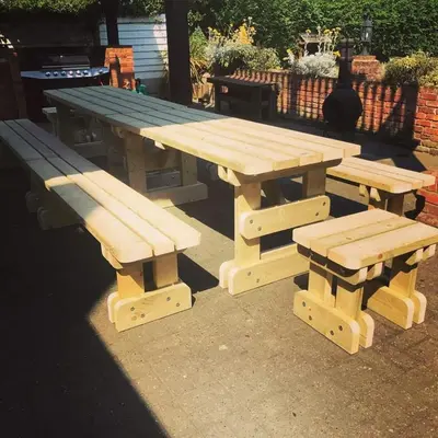 a picnic table and two benches sitting next to each other at Bellropes Countryside Retreat in Bradwell on Sea