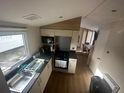 an overhead view of a kitchen with a sink at 4 Bed 10 Berth Caravan Seawick Holiday Park in Saint Osyth