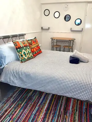 a bedroom with a bed and a table at Penn Gardens king size on suite room- 3 in Friern Barnet