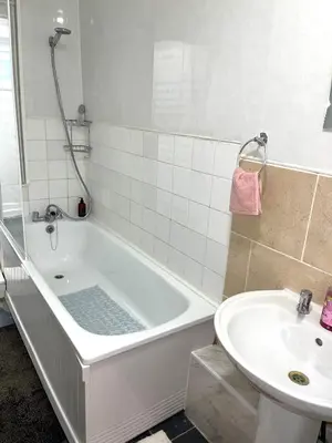 a bathroom with a bath tub and a sink at Penn Gardens king size on suite room- 3 in Friern Barnet