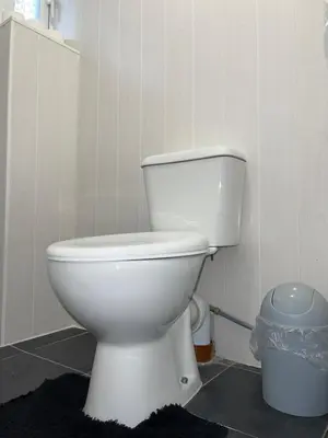 a bathroom with a white toilet in a room at Penn Gardens king size on suite room- 3 in Friern Barnet