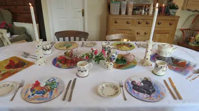 a table with plates and utensils on it at Newmans Lodge in Lavenham
