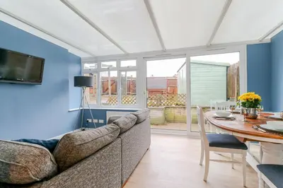 a living room with a couch and a table at Tiger House Stevenage 5 Bed 4 Bath Group Bookings in Stevenage
