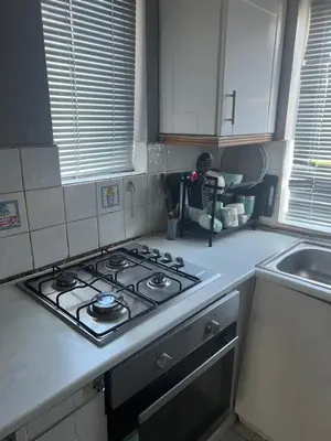 a kitchen counter with a stove and a sink at Private Room in Basildon in Vange