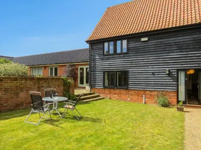 a table and chairs in the yard of a house at 3 Hazlewood in Aldringham