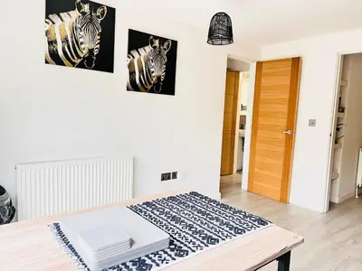 a bedroom with two pictures of zebras on the wall at Stylish Cambridge Apartment with Garden in Cambridge