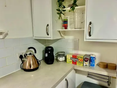 a kitchen counter with a tea kettle on it at 6 Bedroom House - DISC0UNTS - Parking, Contractors, Group, Family in Ipswich
