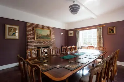 a dining room with a long table and chairs at FIRS Sleeps 15 Stunning country house with hot tub in Sudbourne