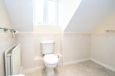 a bathroom with a toilet and a window at Group Retreat Perfect Home with FREE Parking in Freston
