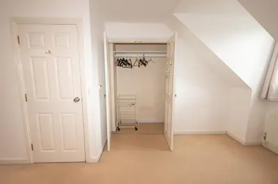 an attic room with a white door and a closet at Group Retreat Perfect Home with FREE Parking in Freston