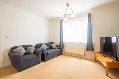 a living room with a couch and a tv at Group Retreat Perfect Home with FREE Parking in Freston