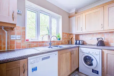 a kitchen with a sink and a washing machine at Group Retreat Perfect Home with FREE Parking in Freston