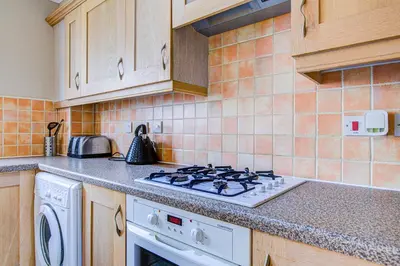 a kitchen with a stove top oven in a kitchen at Group Retreat Perfect Home with FREE Parking in Freston