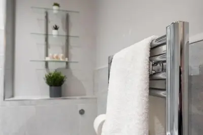 a bathroom with a towel hanging on a towel rack at Beautiful, Spacious 1 bed flat in Brentwood