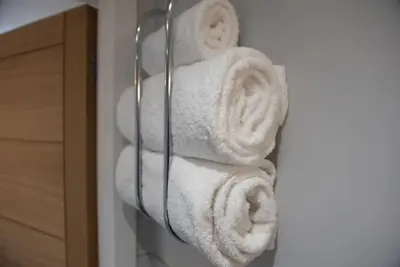 a bunch of towels hanging on a towel rack at Beautiful, Spacious 1 bed flat in Brentwood