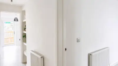 a hallway with two white radiators in a room at Cambridge - Modern 4-BR Home with Gardens & Wi-Fi in Cambridge